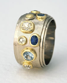 Nicola's Coiled ring with antique cut diamonds, blue Sapphire and Aqua-marine